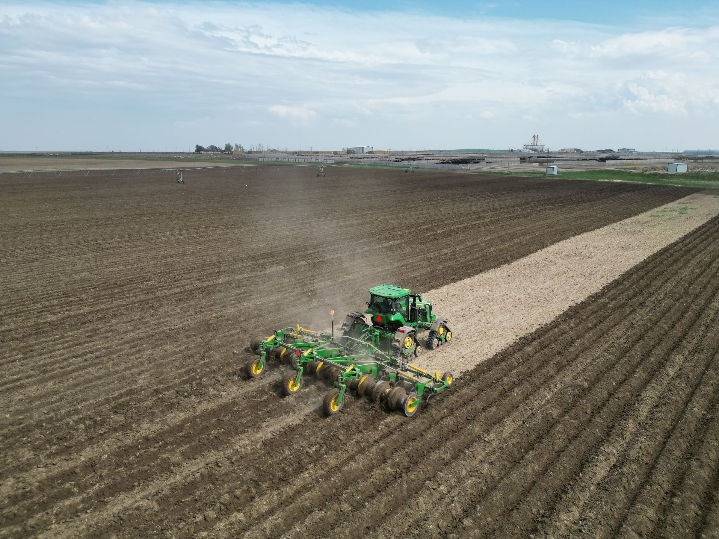 Dirty Hiller building potato hills in the field